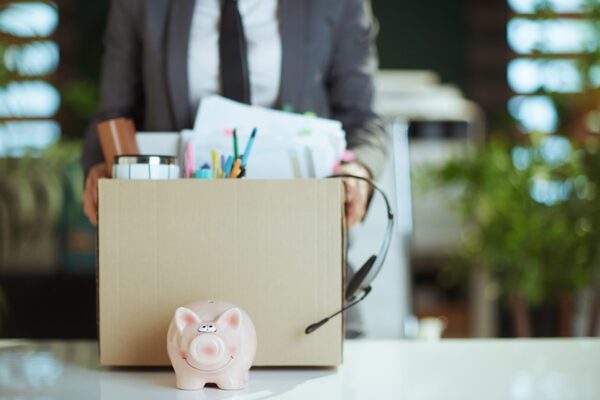 Photo of a woman packing up her belongings at her desk.