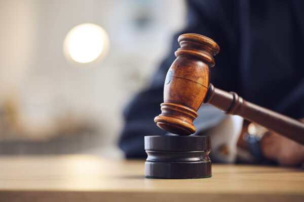 Photo of a judge's gavel in a courtroom.