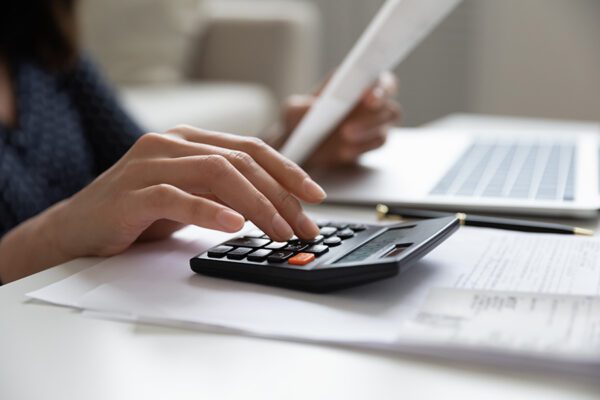 Close up a woman calculating taxes.