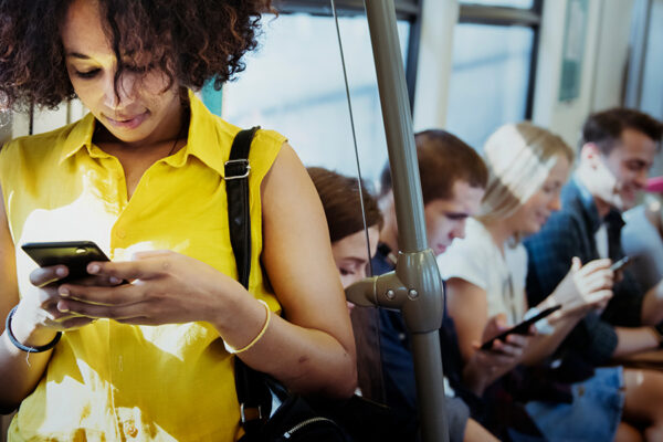 Young woman using a smartphone in a subway.