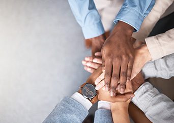 Business people, hands stack and support above for collaboration and inclusion in office for equality. Workplace community, staff and huddle together for solidarity and cooperation with team building